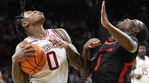Razorbacks Khalif Battle and Gardner-Webb's Julien Soumaoro collide